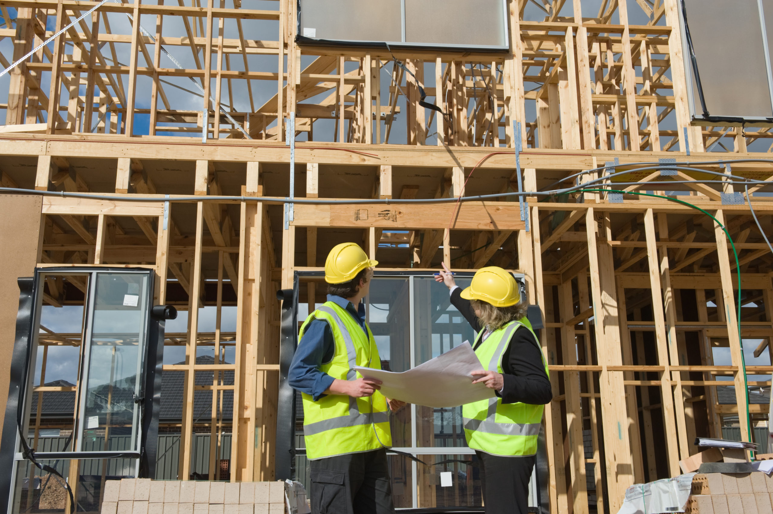 Civil engineer and worker discussing issues at the construction site